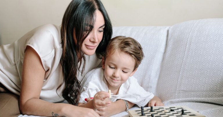 Mother and child enjoy a family ritual of playing a boardgame together.