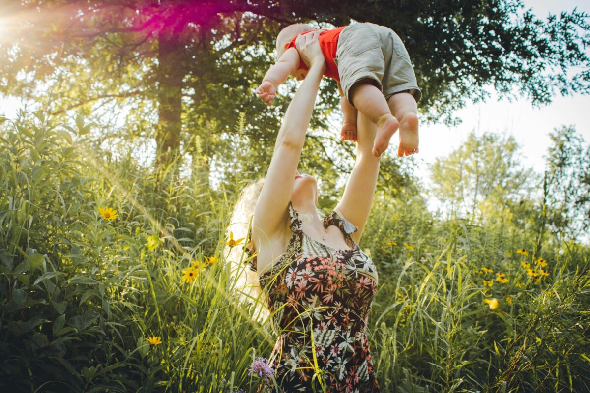 Embrace change and embrace happy life - mother playing with child in the garden